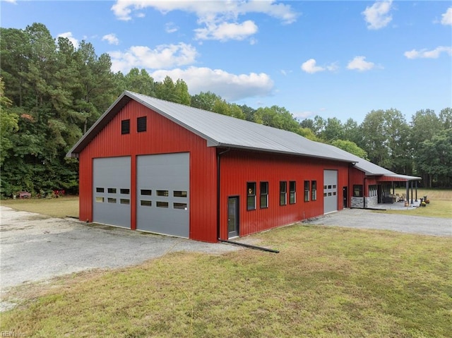 garage with a yard and wooden walls