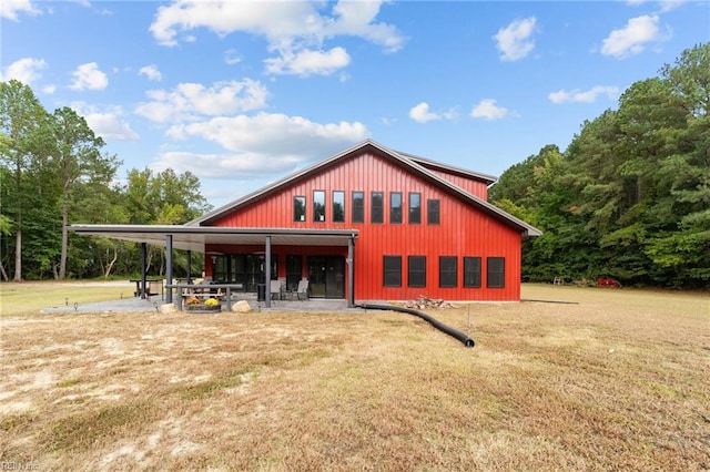 rear view of house featuring a yard and a patio area