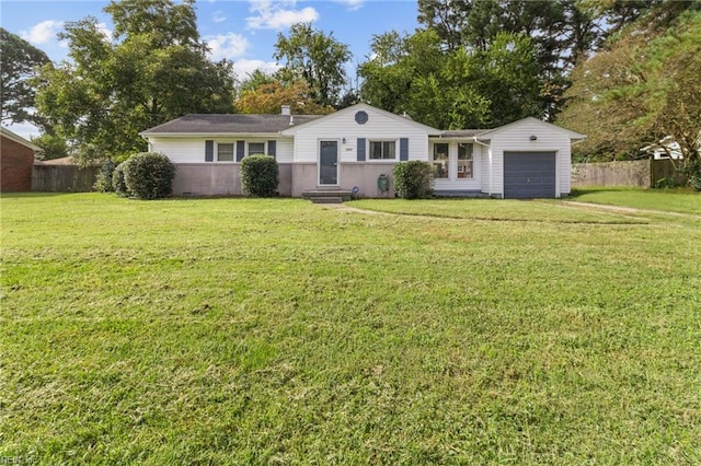 view of front of house with a front yard and a garage