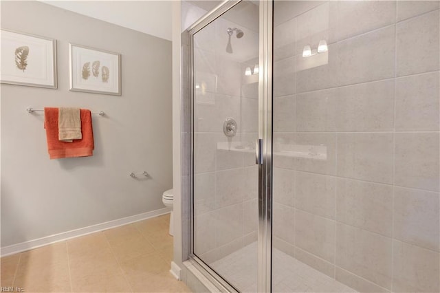 bathroom with walk in shower, tile patterned flooring, and toilet