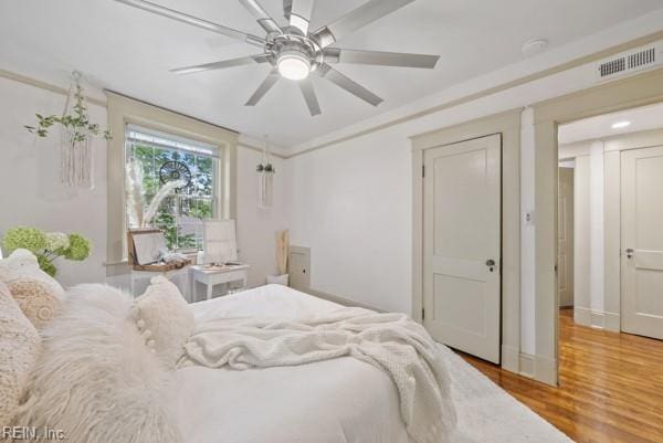 bedroom with ceiling fan and wood-type flooring