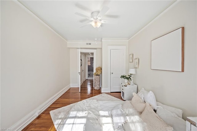 bedroom with ceiling fan, dark hardwood / wood-style floors, and crown molding