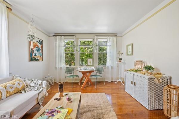 living room featuring hardwood / wood-style floors and ornamental molding