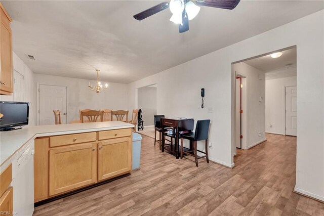 kitchen featuring white dishwasher, ceiling fan with notable chandelier, light brown cabinetry, decorative light fixtures, and light hardwood / wood-style floors