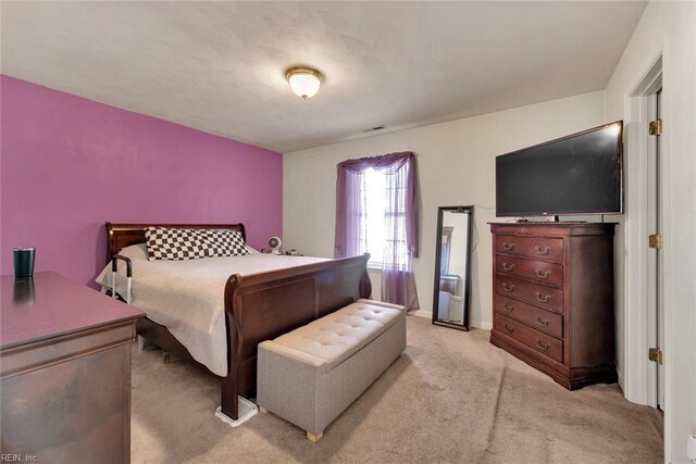 bedroom featuring light carpet