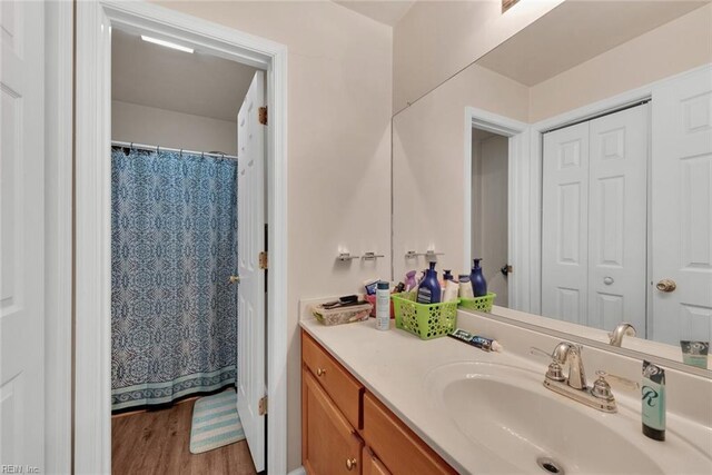 bathroom featuring hardwood / wood-style flooring and vanity