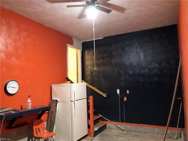 misc room with ceiling fan and concrete flooring