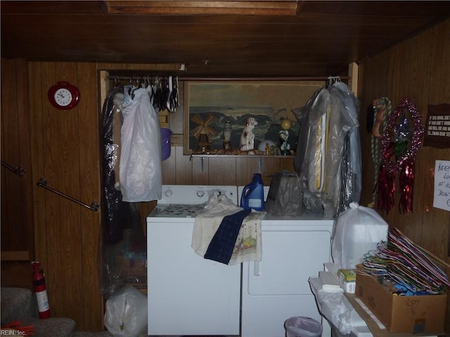 laundry area with washer and clothes dryer, wood walls, and wooden ceiling