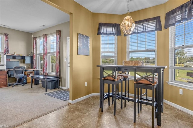 dining room featuring carpet floors and an inviting chandelier