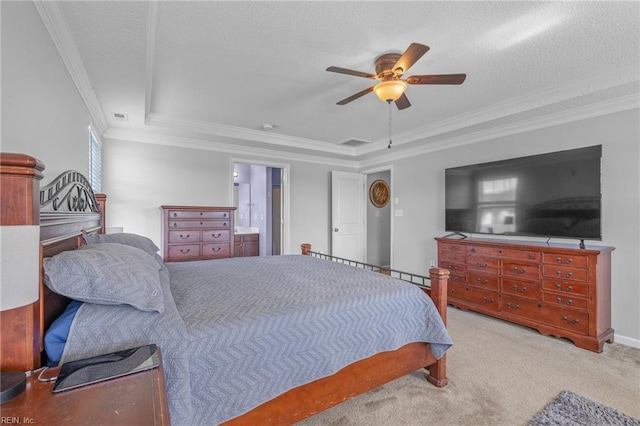 carpeted bedroom with ensuite bathroom, a textured ceiling, a raised ceiling, ceiling fan, and crown molding