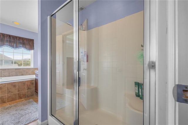 bathroom with separate shower and tub