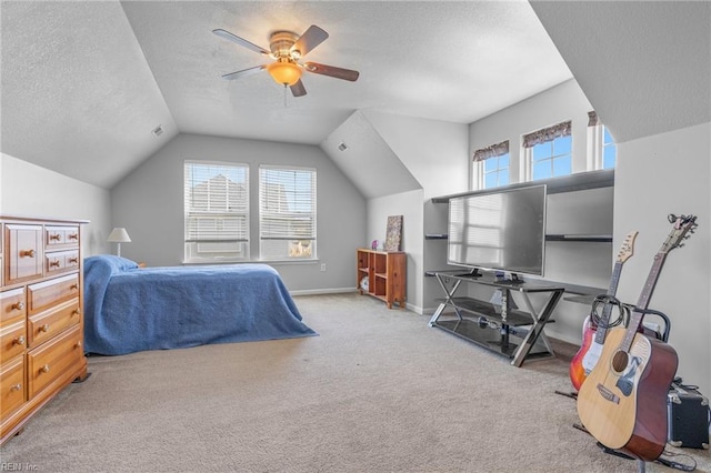 bedroom with light carpet, a textured ceiling, vaulted ceiling, and ceiling fan