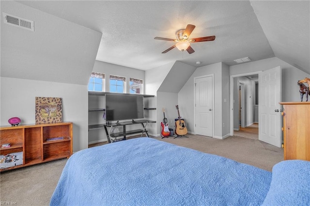 carpeted bedroom with a textured ceiling, ceiling fan, and lofted ceiling