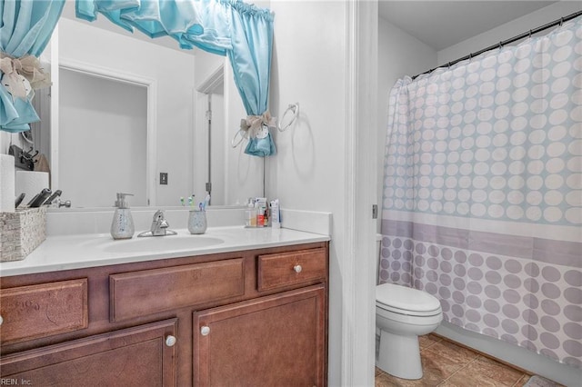 bathroom featuring tile patterned floors, vanity, toilet, and curtained shower