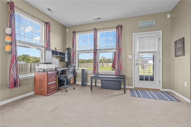 home office featuring a healthy amount of sunlight and light carpet