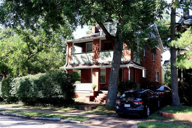 view of front of home with a balcony and covered porch