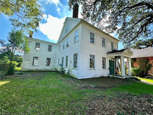 rear view of property featuring a yard