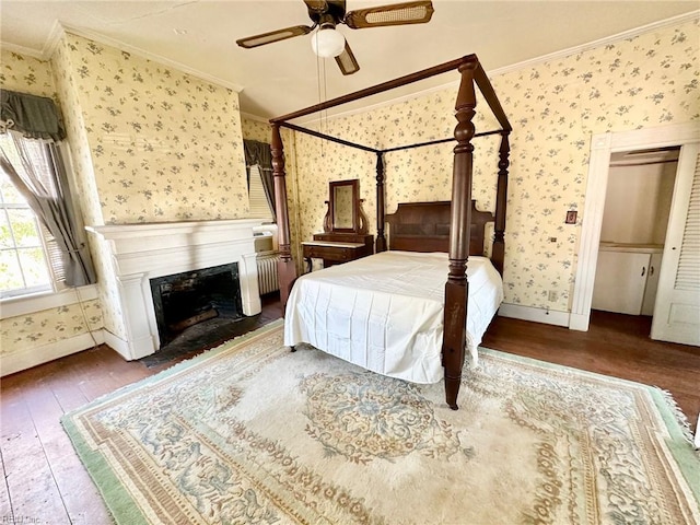 bedroom with ceiling fan, crown molding, and dark hardwood / wood-style floors