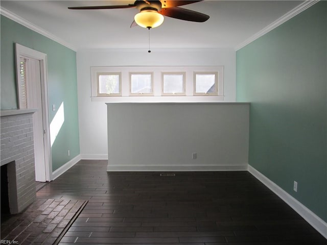 unfurnished living room with dark wood-type flooring, a brick fireplace, ornamental molding, and ceiling fan