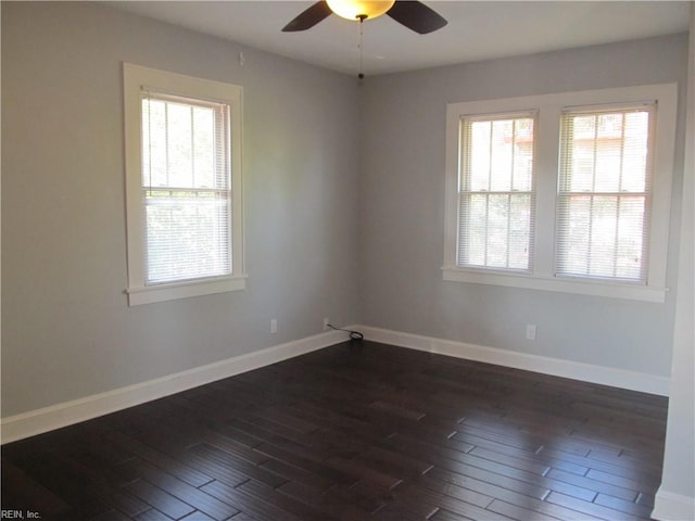 spare room featuring dark hardwood / wood-style flooring and ceiling fan