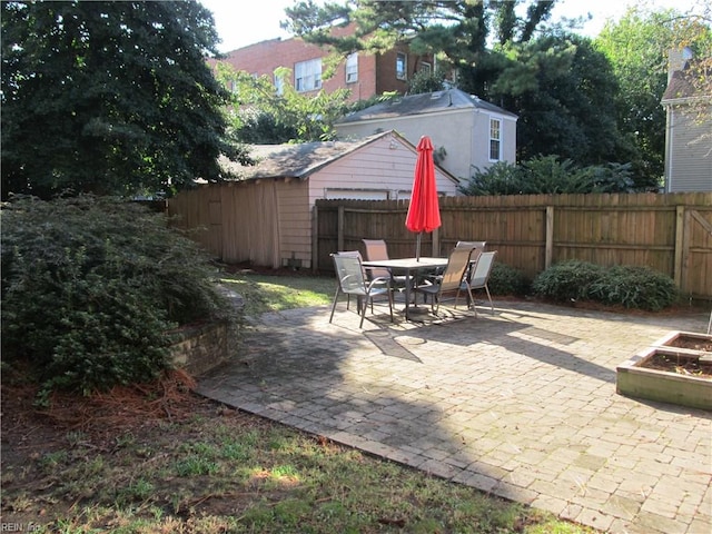 view of patio featuring a storage unit