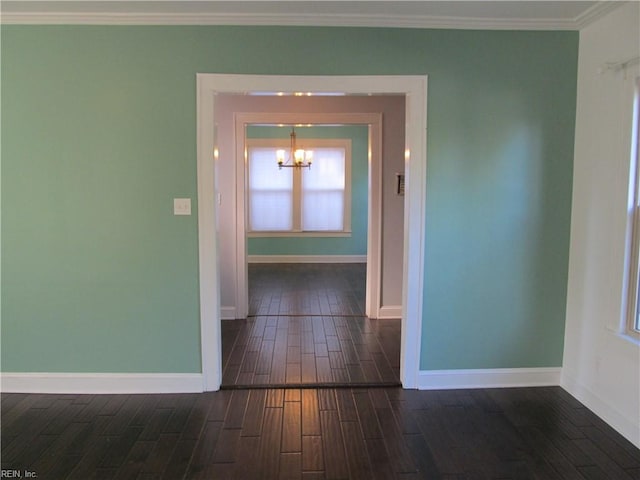 hall featuring a notable chandelier, crown molding, and dark hardwood / wood-style floors