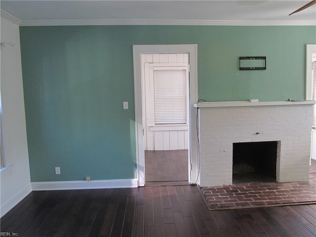 unfurnished living room featuring a fireplace, dark hardwood / wood-style floors, and crown molding