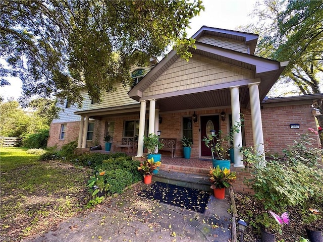 1057 W Rd, Chesapeake, VA 23323 - view of front facade featuring covered porch and brick siding
