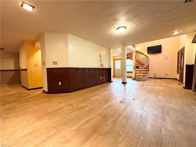 1057 W Rd, Chesapeake, VA 23323 - unfurnished living room featuring light wood-style floors, stairs, and baseboards