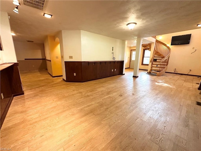 1057 W Rd, Chesapeake, VA 23323 - unfurnished living room featuring baseboards, light wood-style flooring, and stairs