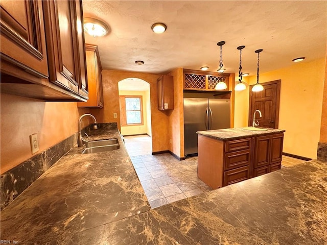 1057 W Rd, Chesapeake, VA 23323 - kitchen with a sink, stainless steel fridge, and brown cabinets