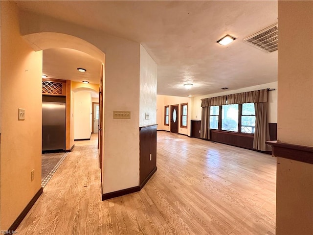 1057 W Rd, Chesapeake, VA 23323 - empty room featuring arched walkways, light wood finished floors, and baseboards