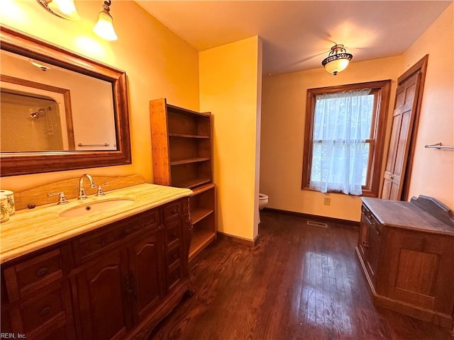 1057 W Rd, Chesapeake, VA 23323 - bathroom featuring toilet, vanity, hardwood / wood-style flooring, and baseboards