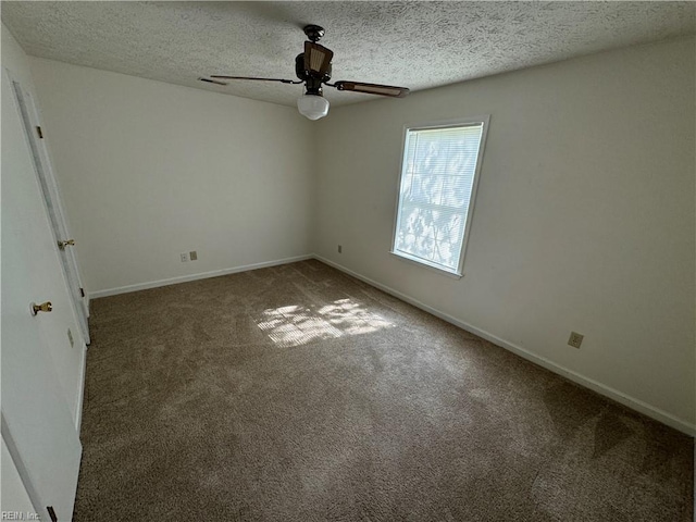 carpeted spare room with a textured ceiling and ceiling fan