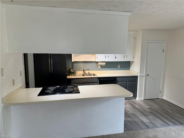 kitchen featuring white cabinets, a textured ceiling, light hardwood / wood-style flooring, black appliances, and sink