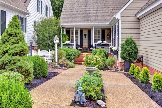 view of exterior entry with covered porch