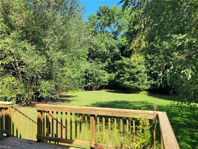 wooden terrace with a yard