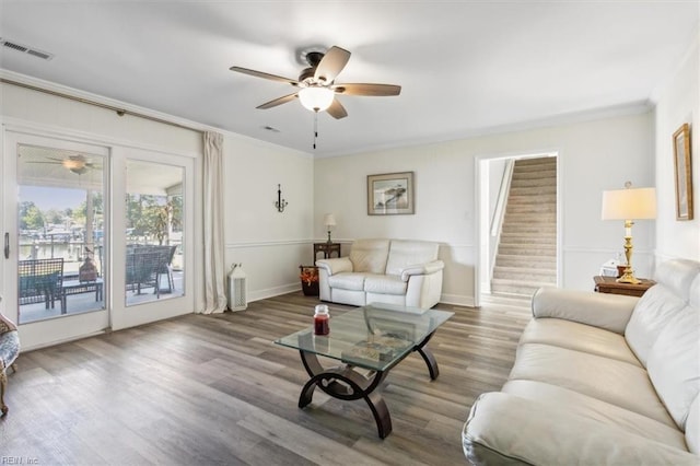 living room with crown molding, hardwood / wood-style flooring, and ceiling fan