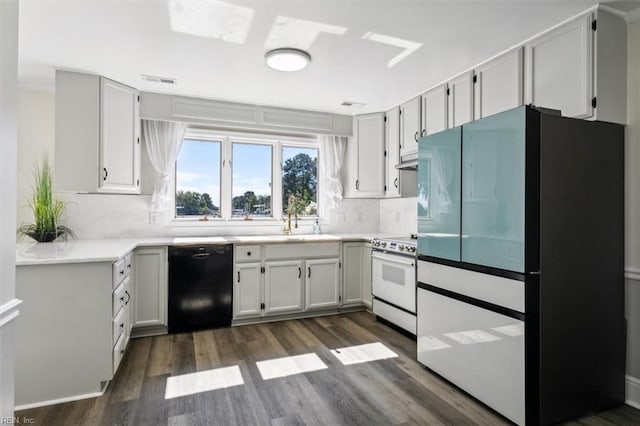 kitchen featuring white electric stove, refrigerator, dark hardwood / wood-style floors, white cabinetry, and dishwasher