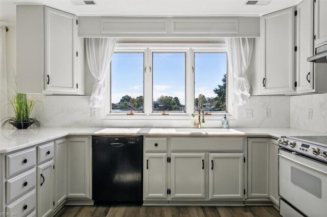 kitchen featuring dark wood-type flooring, sink, black dishwasher, electric stove, and backsplash