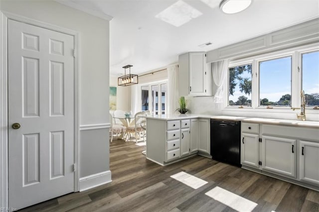 kitchen with pendant lighting, kitchen peninsula, sink, dishwasher, and dark hardwood / wood-style flooring