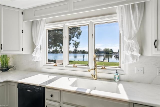 kitchen featuring a water view, a wealth of natural light, and dishwasher