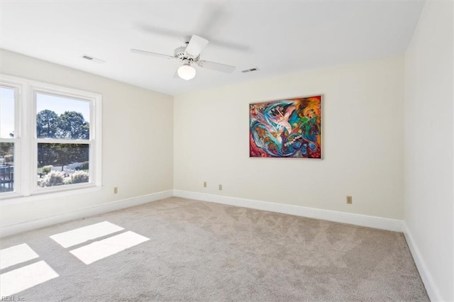 unfurnished room featuring light carpet and ceiling fan