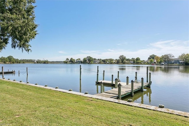 view of dock featuring a water view and a lawn