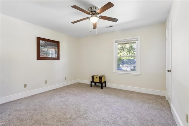 empty room featuring ceiling fan and light colored carpet