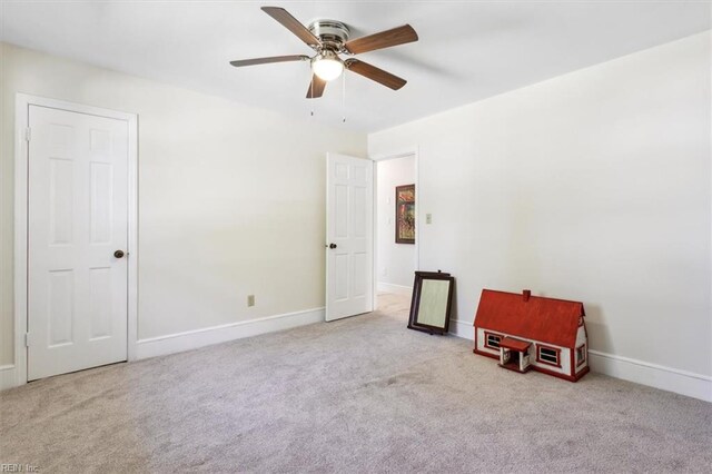 carpeted empty room with ceiling fan