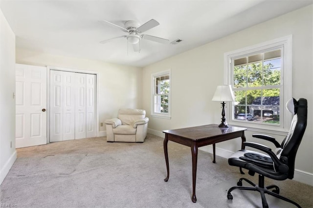 office space with ceiling fan, light carpet, and plenty of natural light