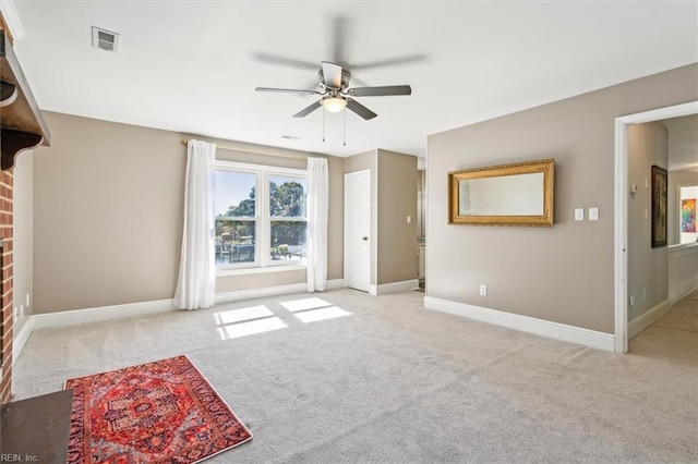 carpeted living room featuring a fireplace and ceiling fan