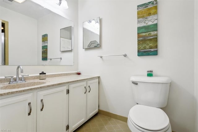 bathroom featuring toilet and vanity