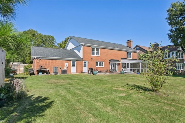 rear view of property featuring a yard